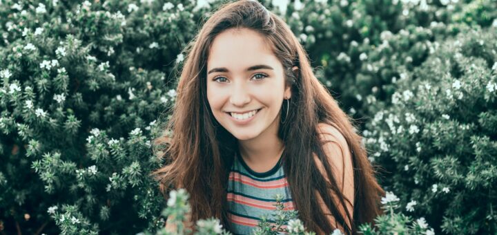 woman standing in bushes