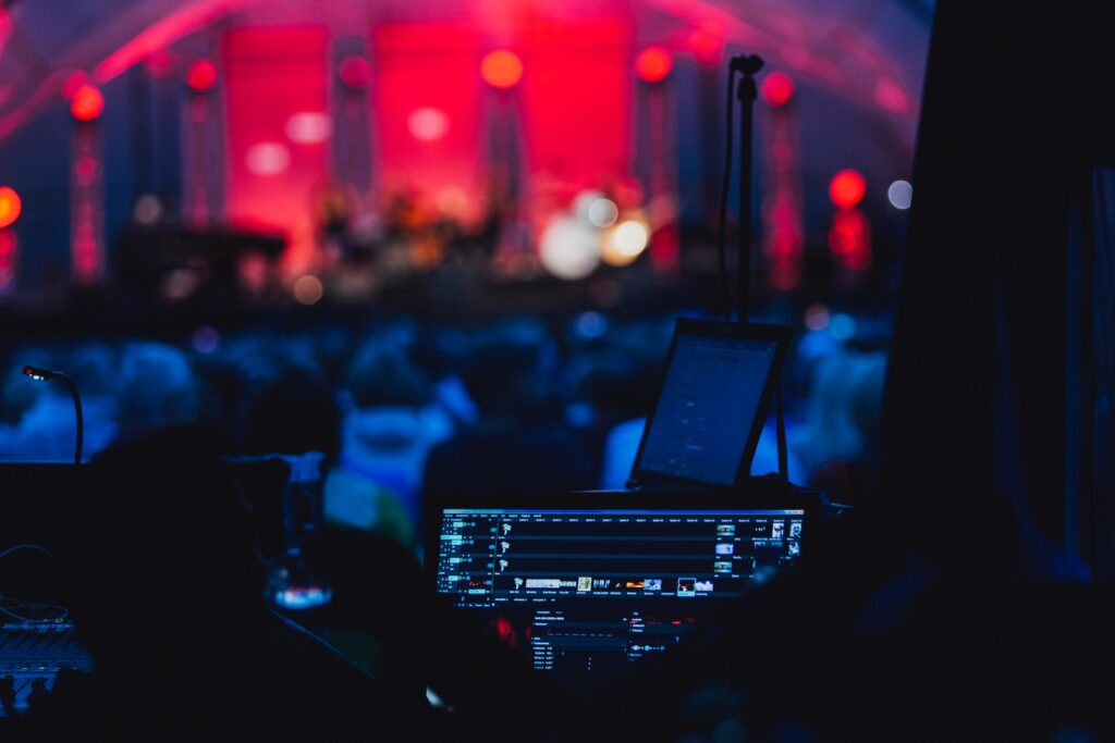 a stage with a laptop and microphone in front of a crowd